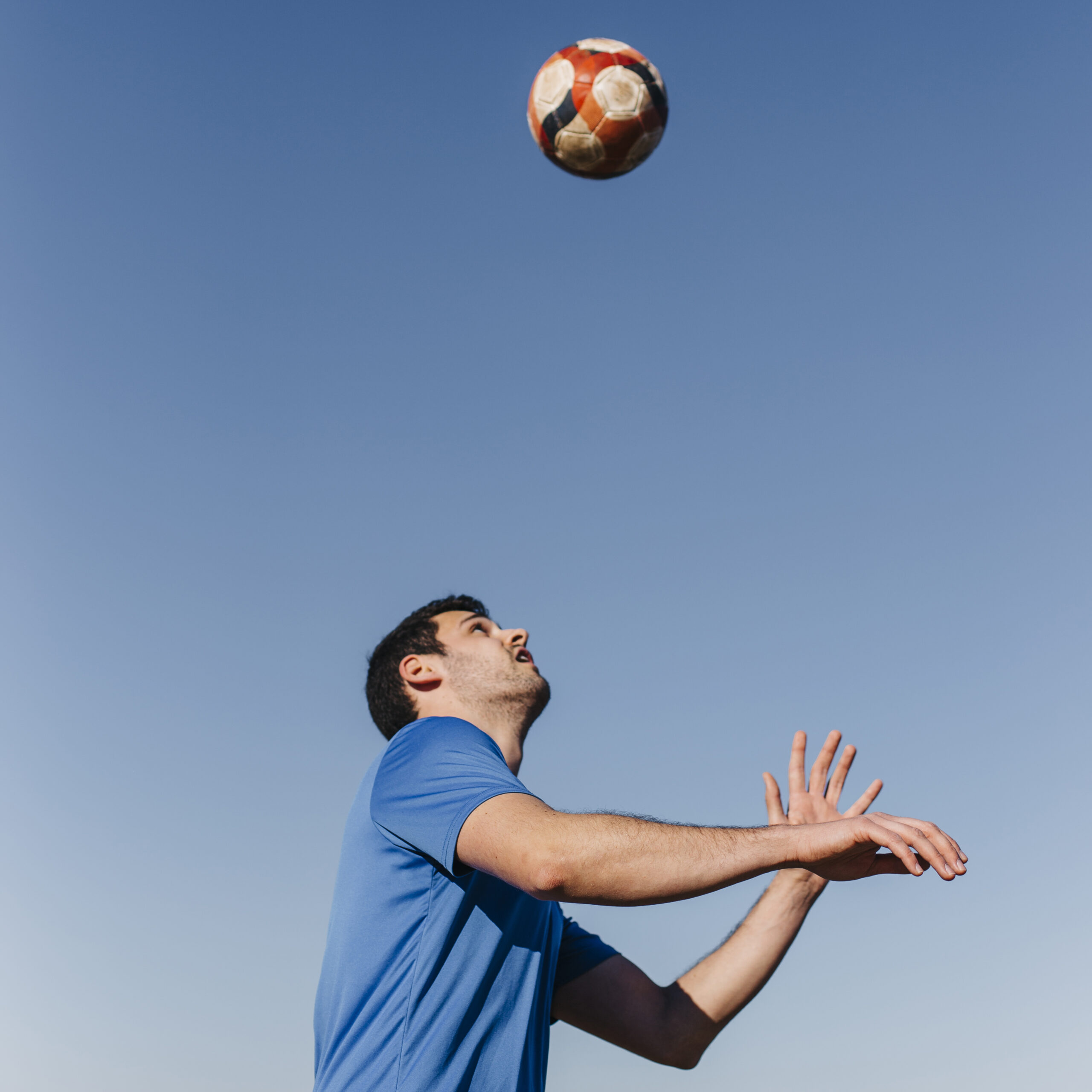 man-playing-football-beach